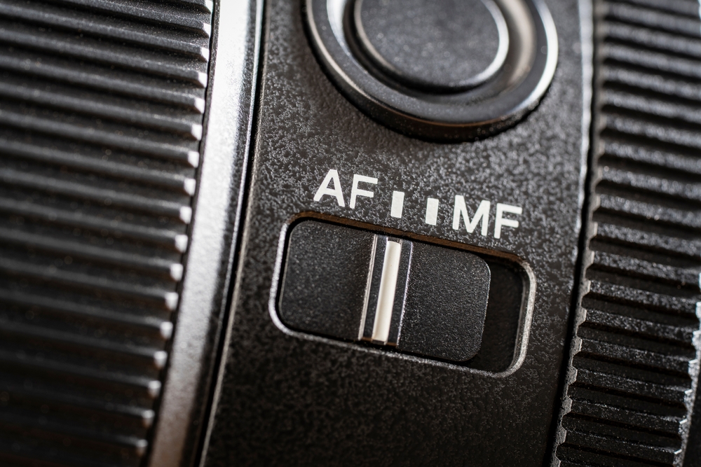 Close up of the auto or manual focus button on a camera lens