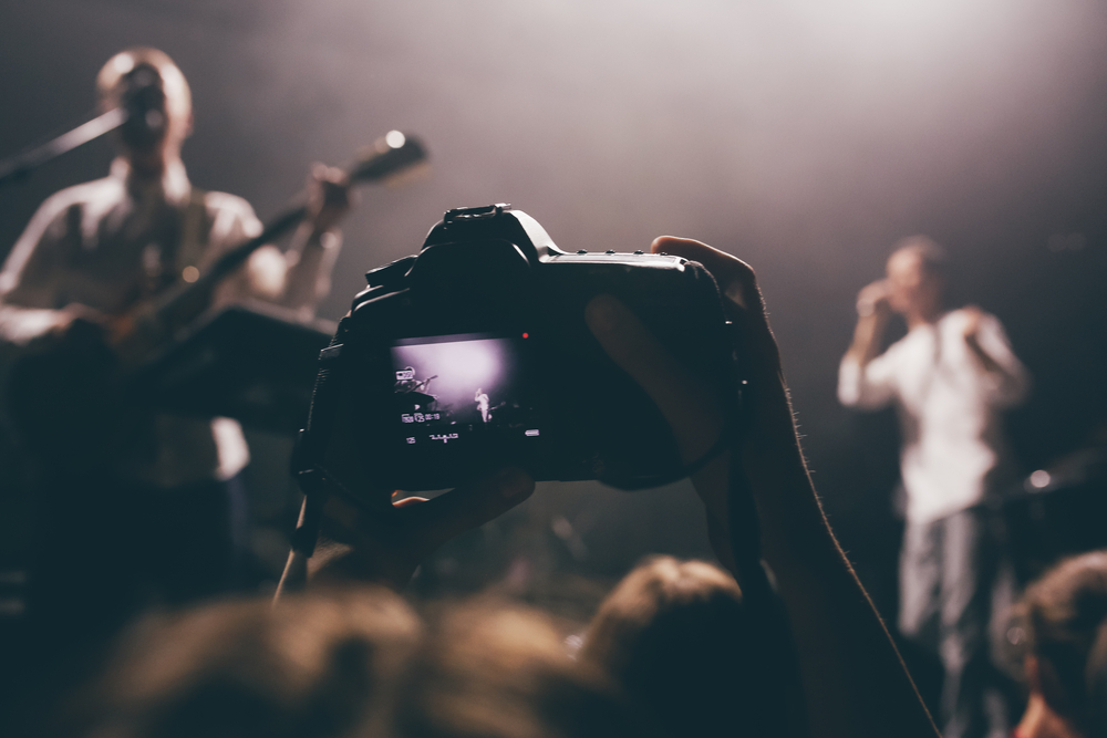 dslr camera with the live view of a concert