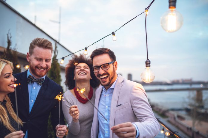 Four friends holding sparklers