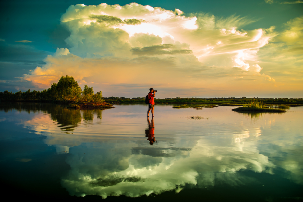 landscape photographer standing in water