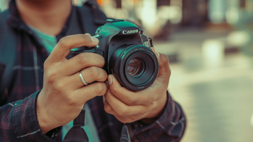 Man Holding Canon Camera