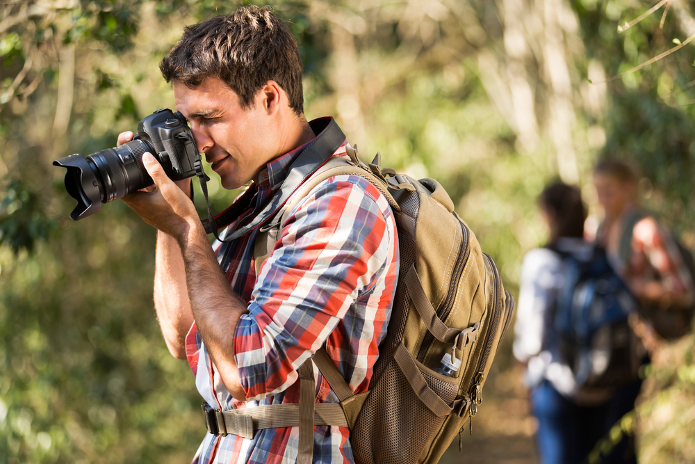 man taking photos during a hike