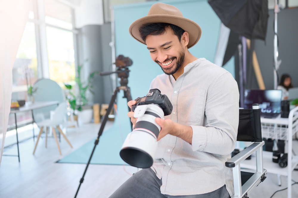 photographer checking his camera in the studio