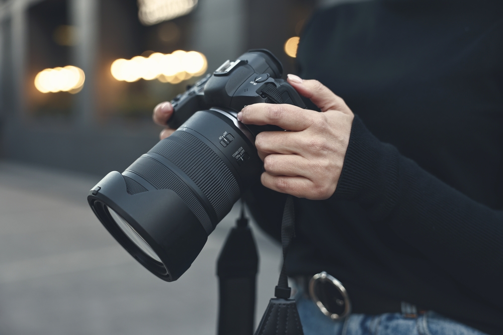 photographer holding a camera closeup