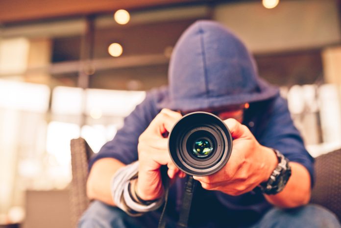 Photographer in a blue hoodie