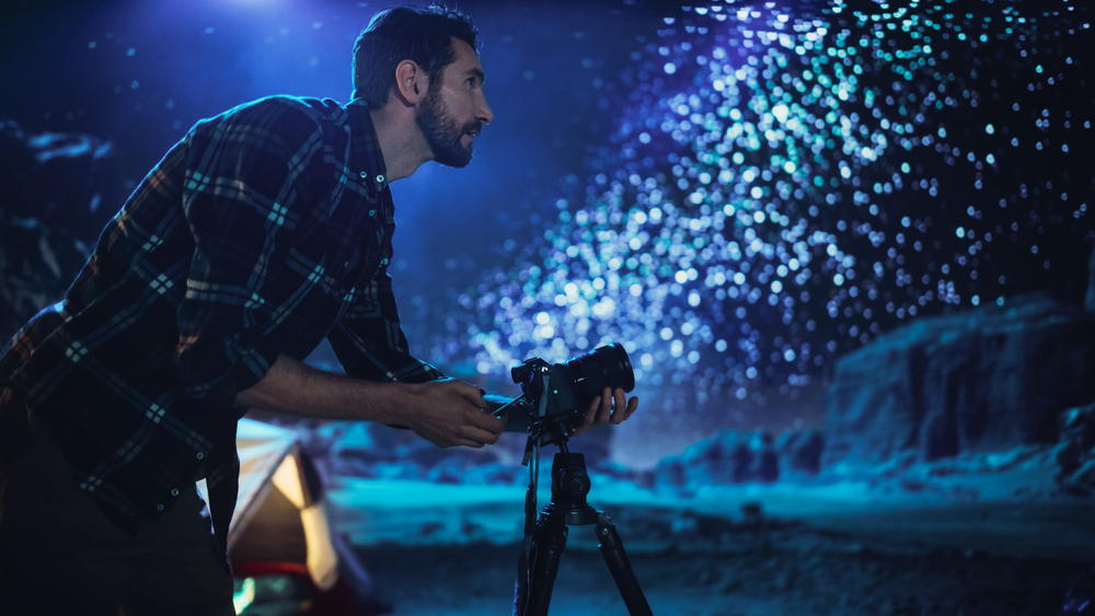 Photographer Prepares His Camera for taking photos of the stars