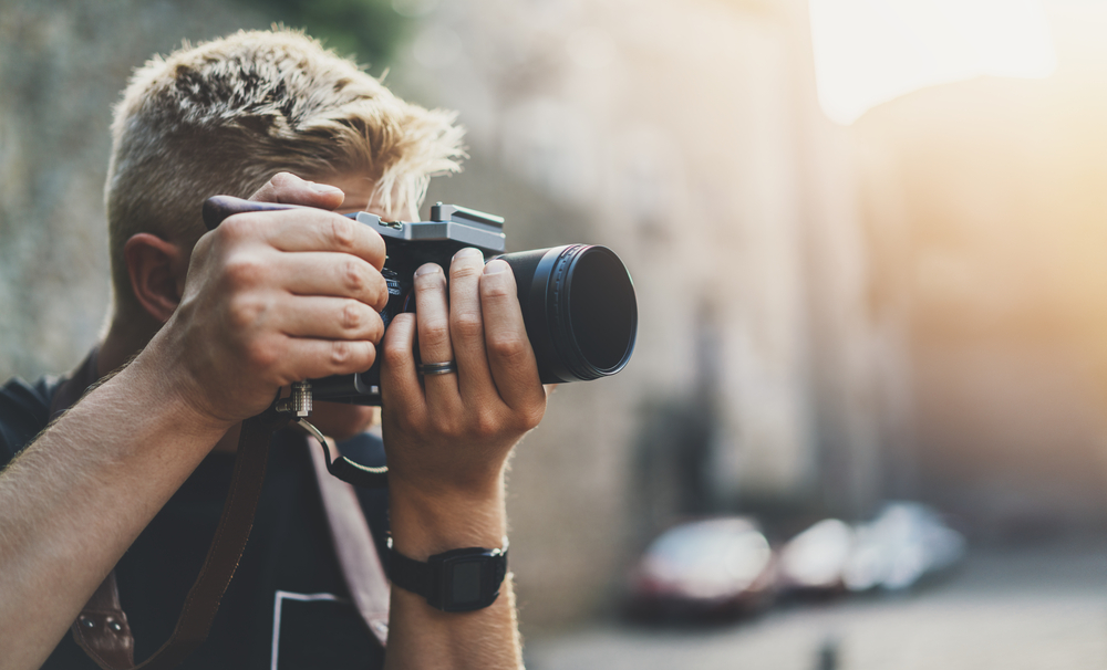 photographer shooting outdoors with a modern camera