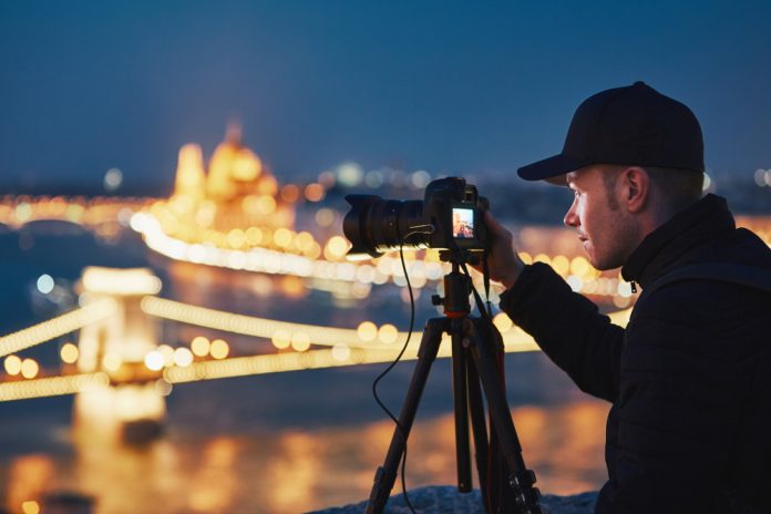photographer taking blue hour cityscape