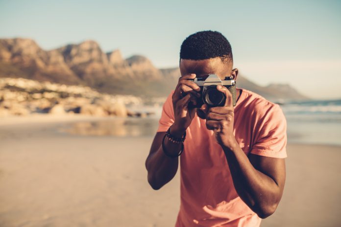photographer taking pictures on the seashore