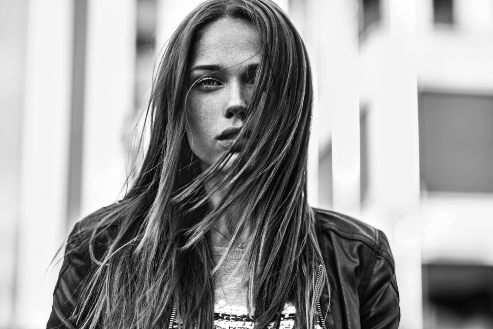 portrait of a woman with her hair in her face BW
