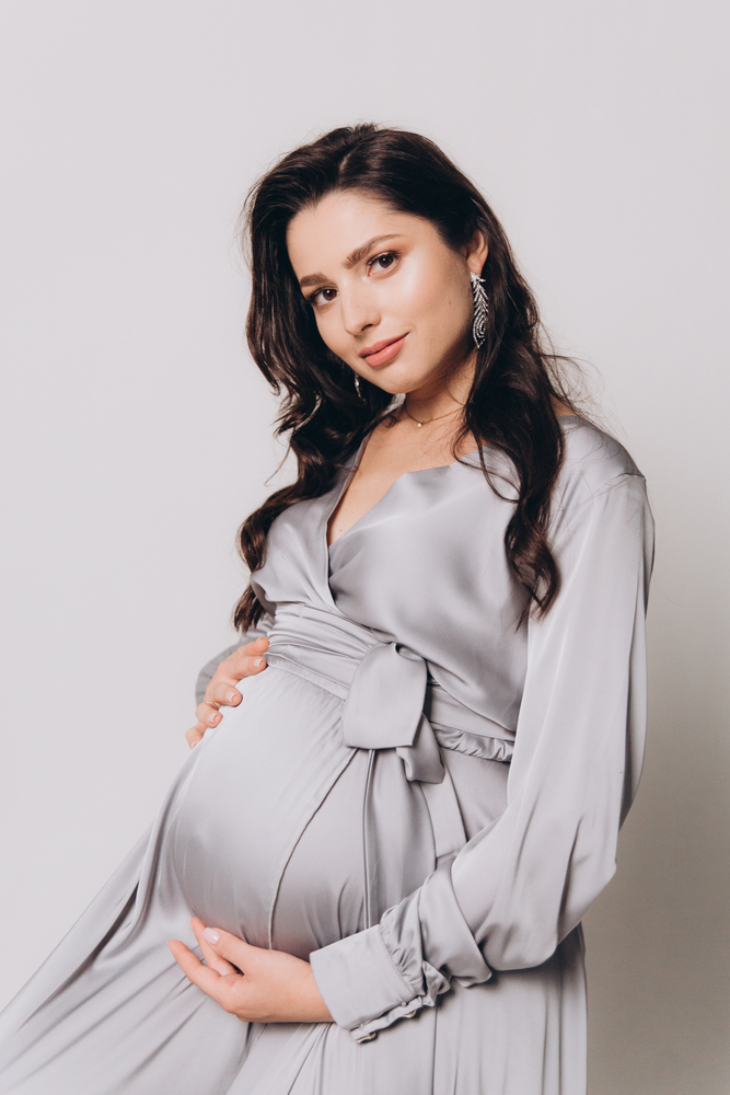 Pregnant woman in a grey dress