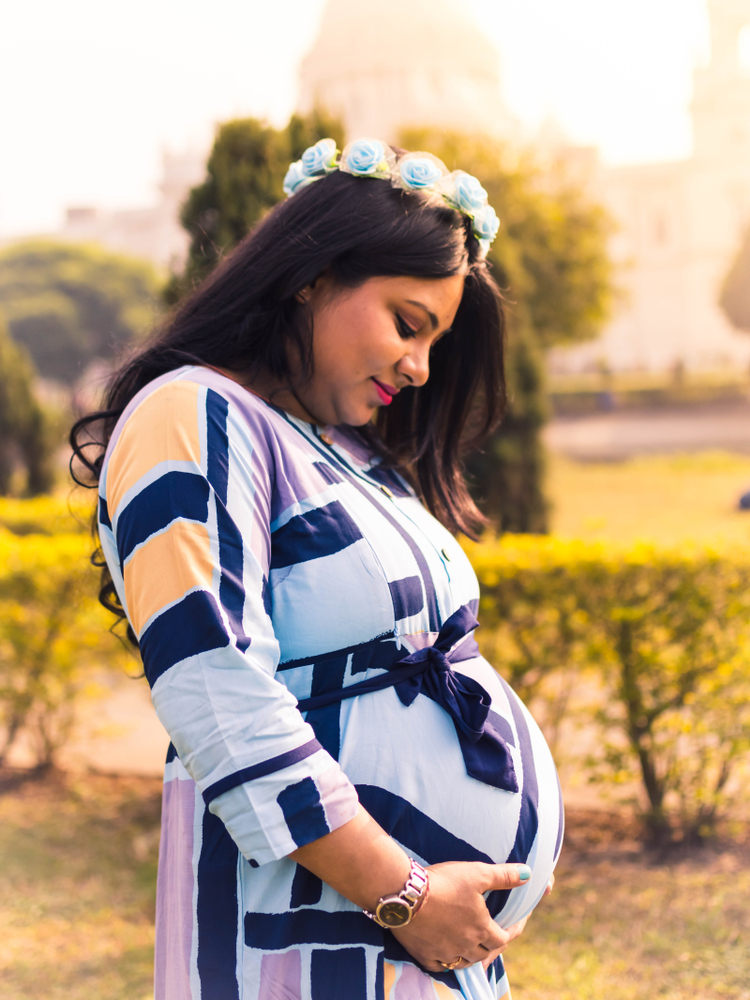 Pregnant woman wearing a flower crown maternity