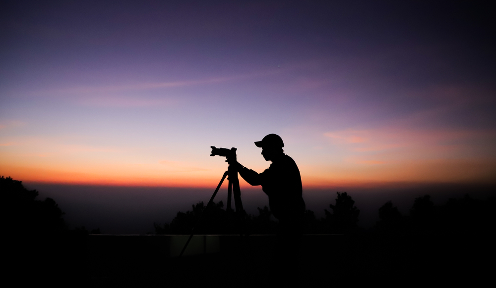 Silhouette of the photographer with tripod