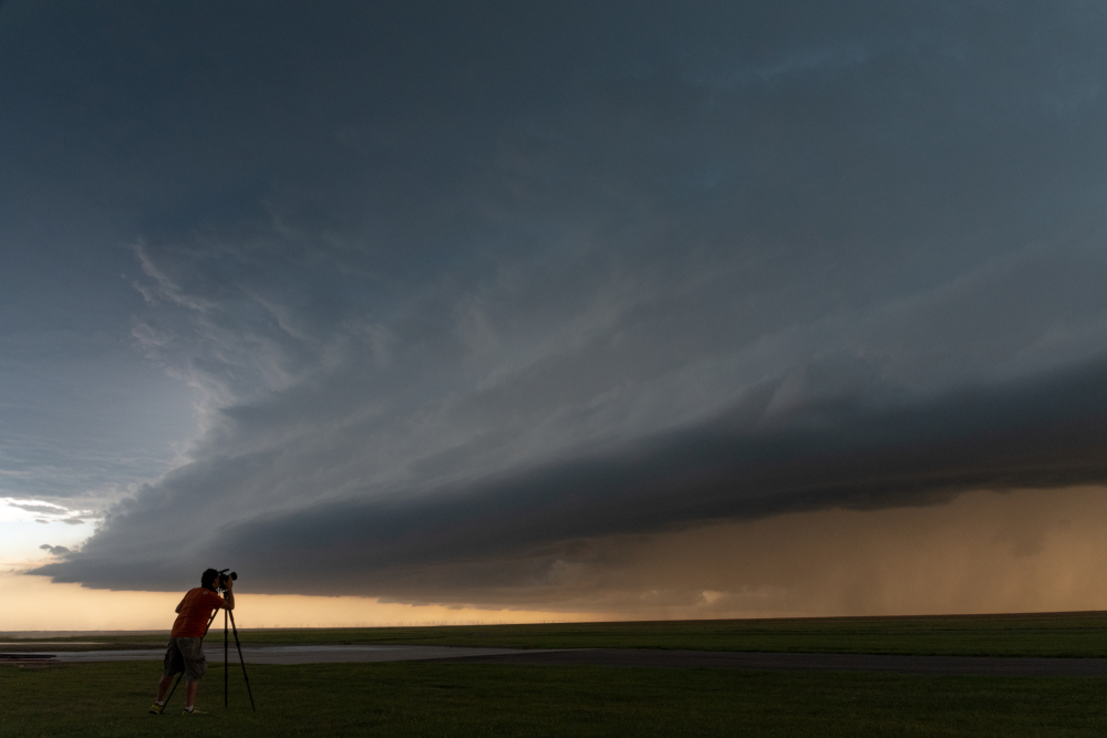 storm photographer with camera and tripod