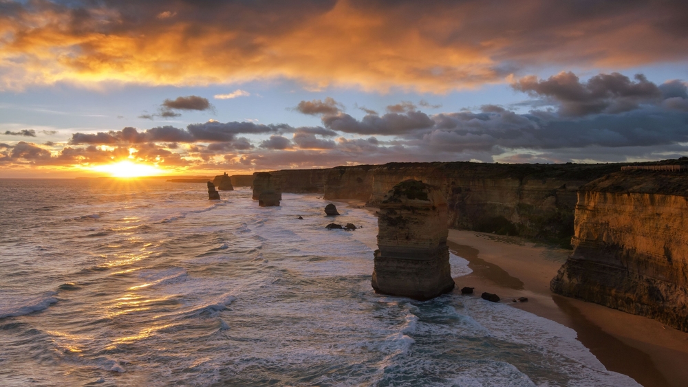 Sunset on a beach with large rock pillars