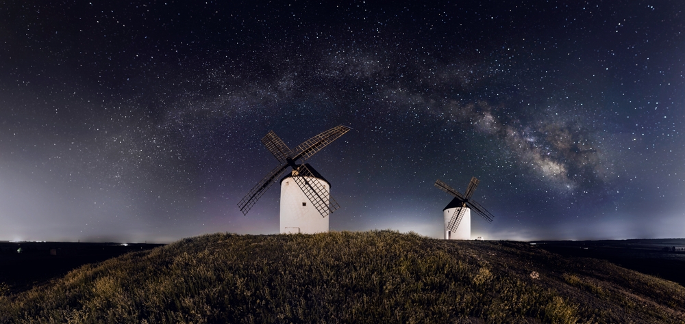Windmills with the sky full of stars and the milky way