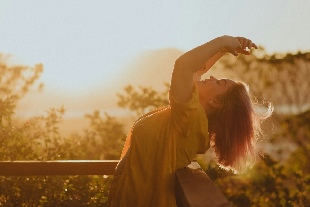 Woman leaning back over a railing