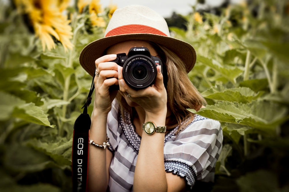 woman using a camera in nature